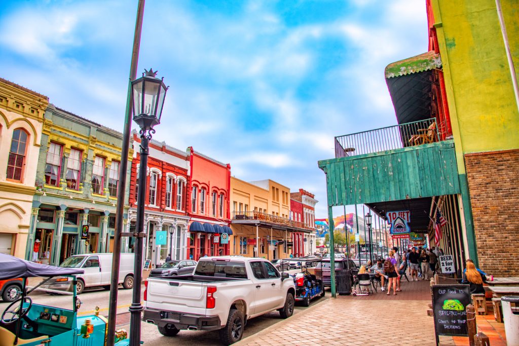 An historic downtown Galveston street lined with old buildings and shoppes reminiscent of the old west. Many of these buildings, built in the 1800s, withstood the massive hurricane of 1900 and still stand in use today.