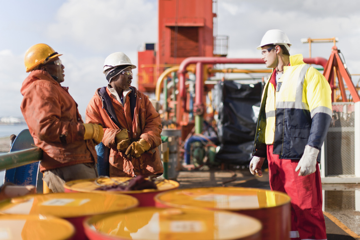 Workers talking on an oil rig.