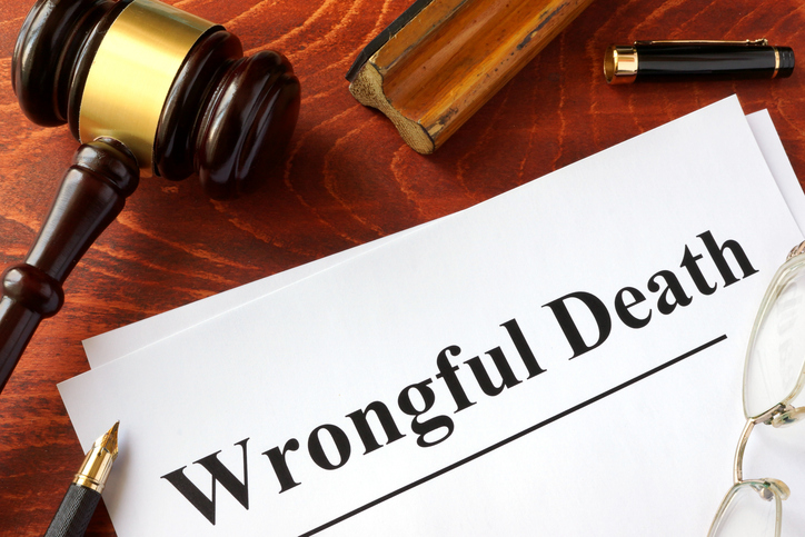 Document with title "Wrongful Death" on a wooden surface.