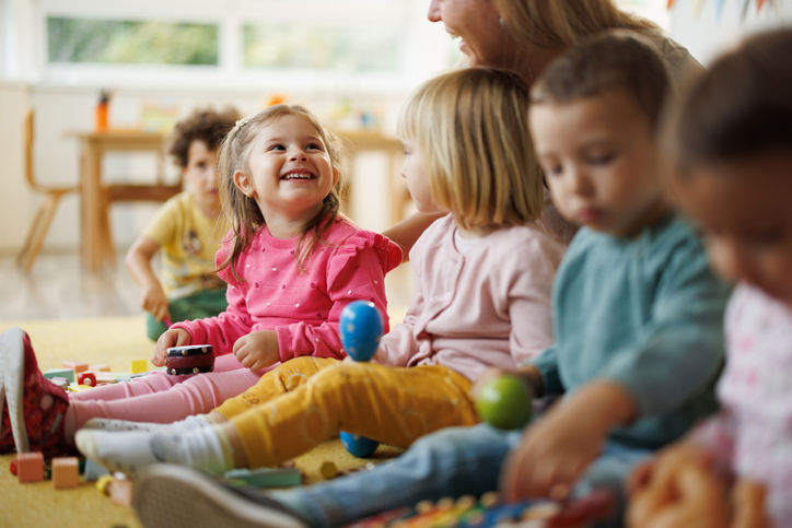 Children explore music through instruments in the nursery with their teacher