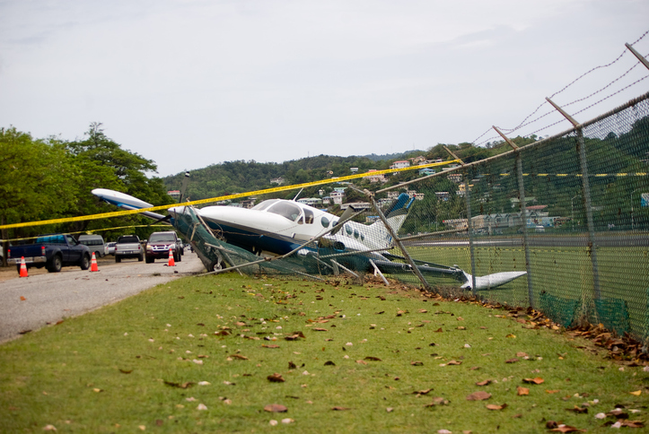 small plane crashes through fence in emergency landing